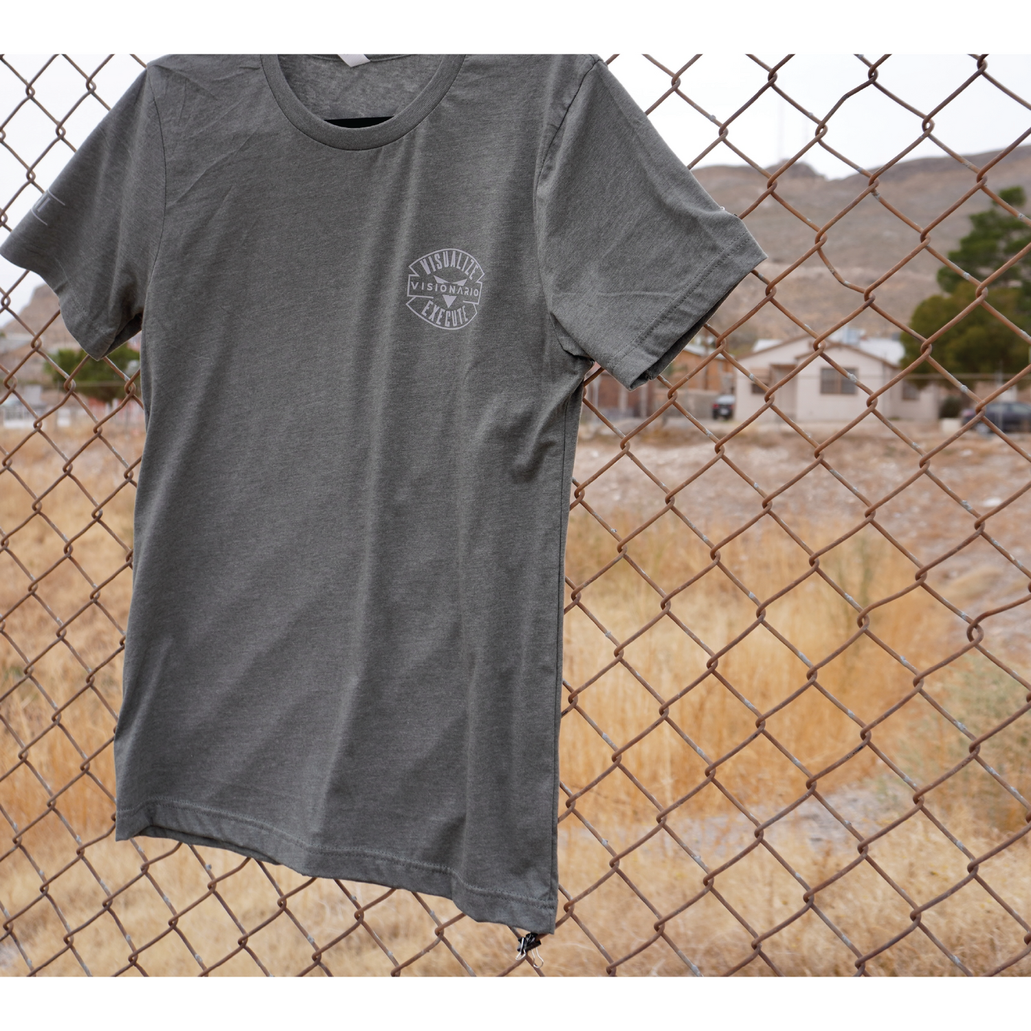 HEATHER MILITARY GREEN TEE GREY AUTHENTIC EMBLEM POCKET SIZE DESIGN (LEFT SIDE). Roman numerals "2021" STAMPED ON RIGHT SLEEVE.